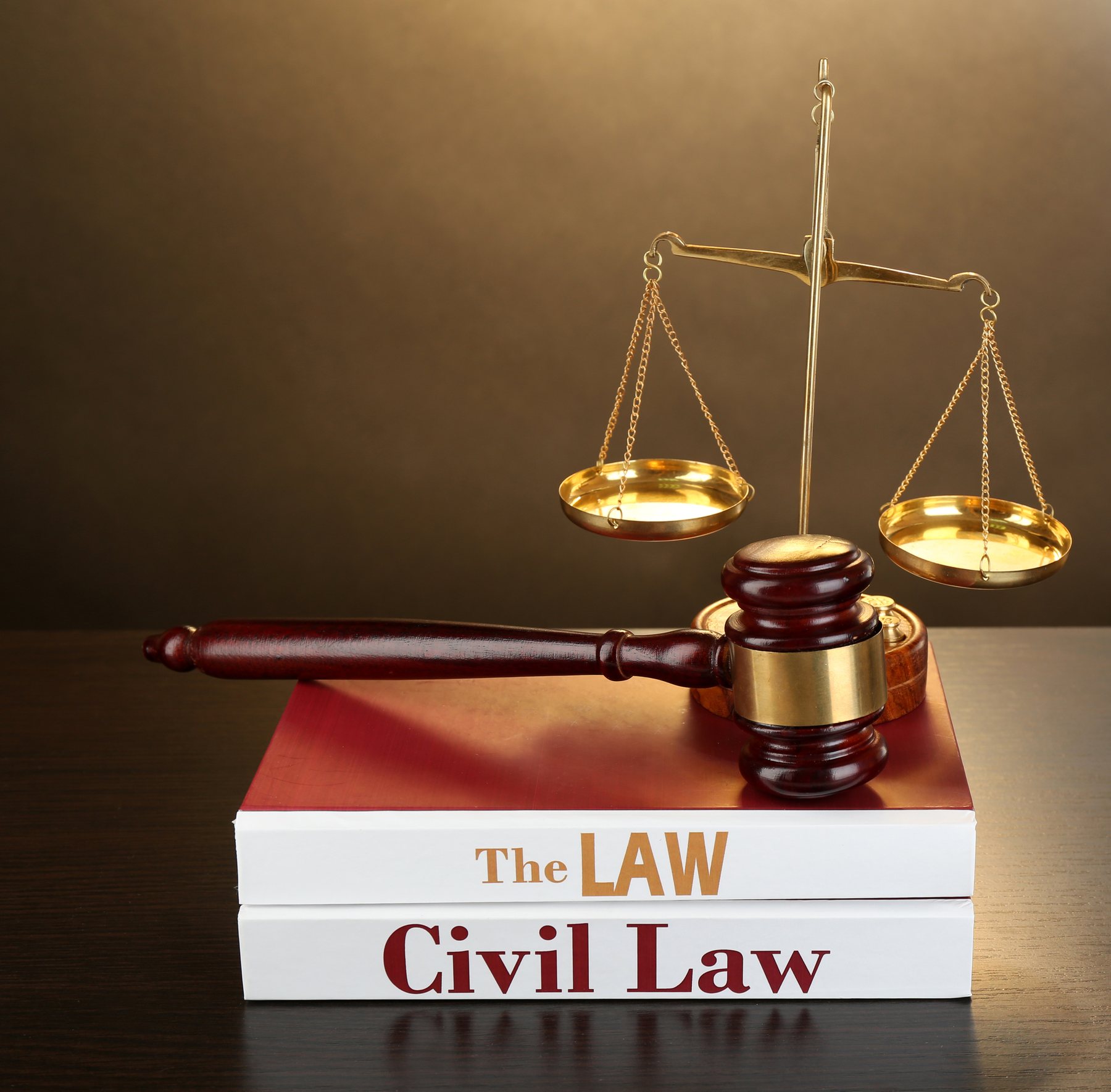 Books of Law on table on brown background. Adobe Stock 70556897.